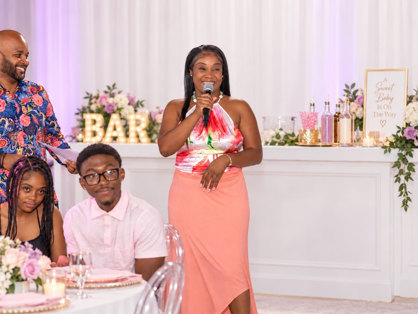 A guest gives a toast with a microphone at a Soleil-designed celebration.
